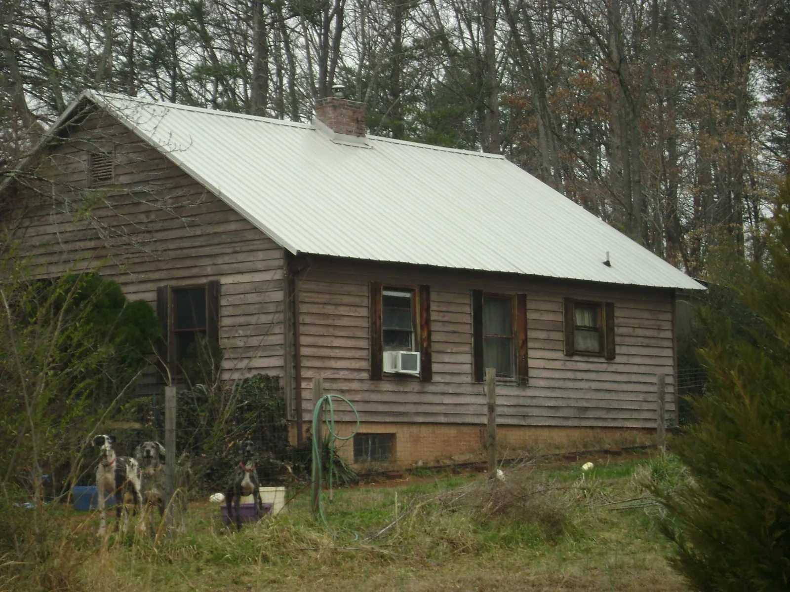 White metal roof on an old wood sided farmhouse, from a Metal Roof Installation job in Roxbury
